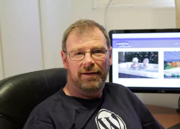A man designing a WordPress website.