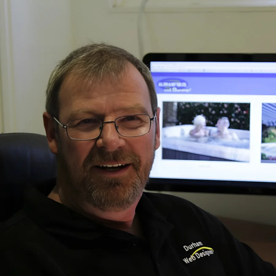 photo of Larry James wearing a blue sports shirt with the logo of Durham Web Designer