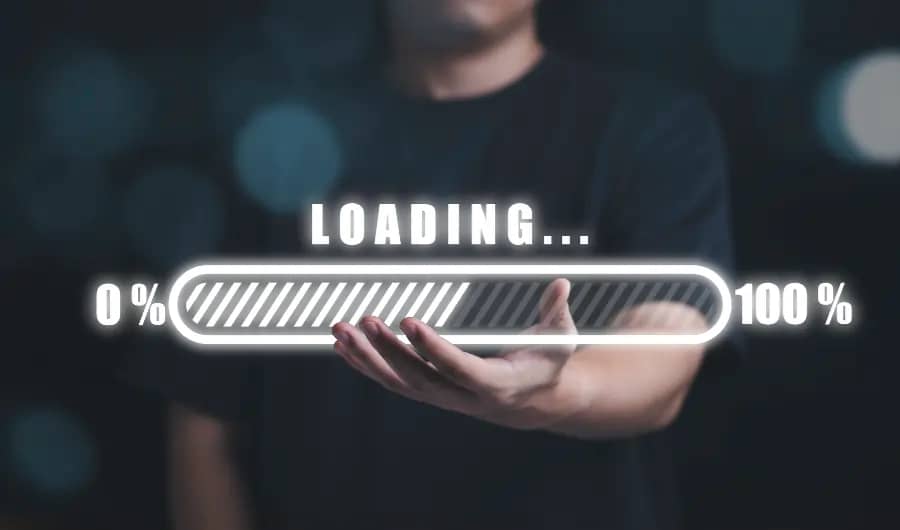 A man is holding up a loading bar on a dark background for website development.