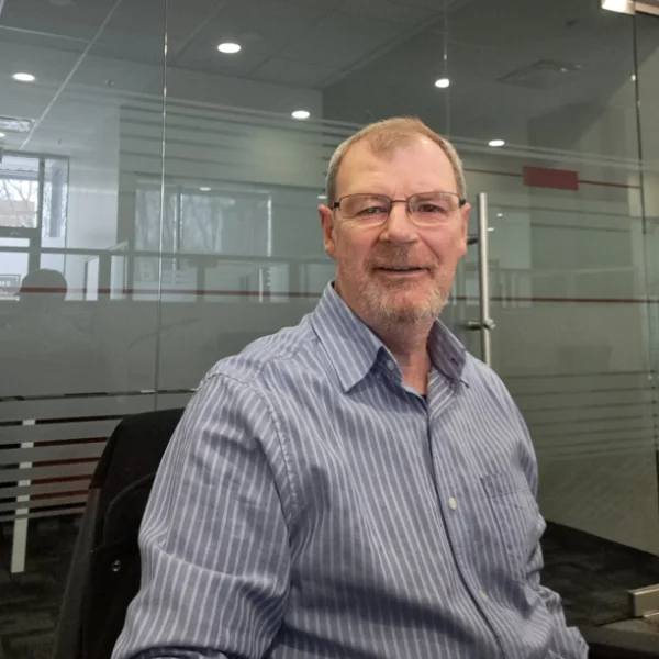 Man in glasses sitting in modern office